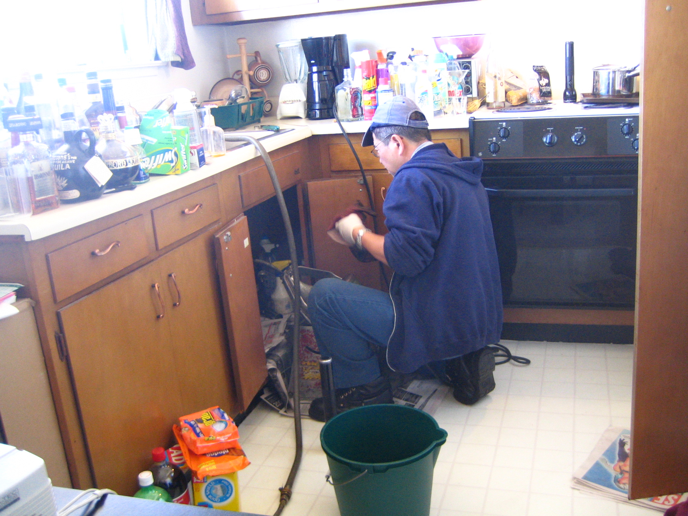 Plumbing Template 1 Layout Showcase - Plumber repairing a kitchen faucet